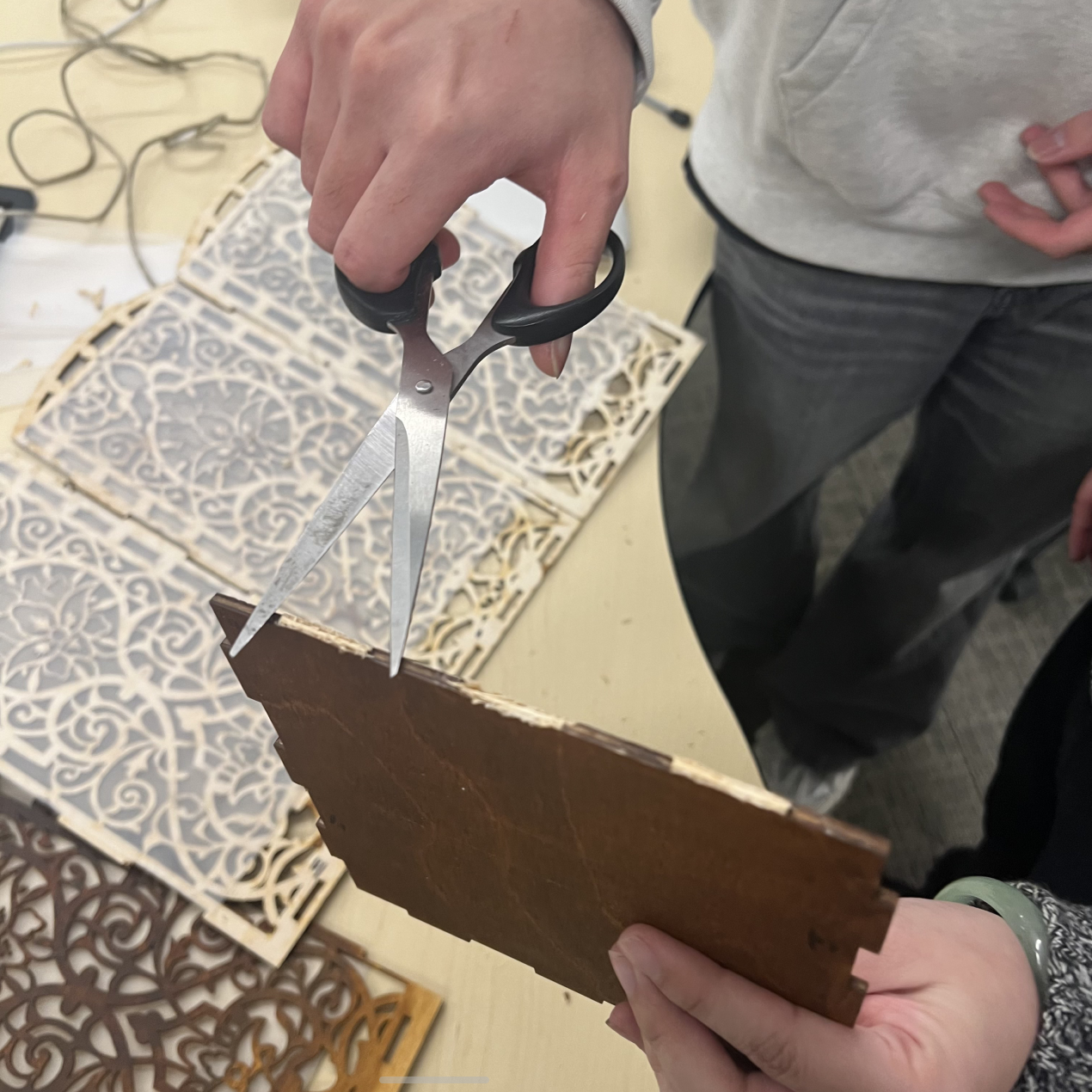 We adjusted the lamp base after laser cutting, trimming one panel by hand because its original dimensions were incorrect.